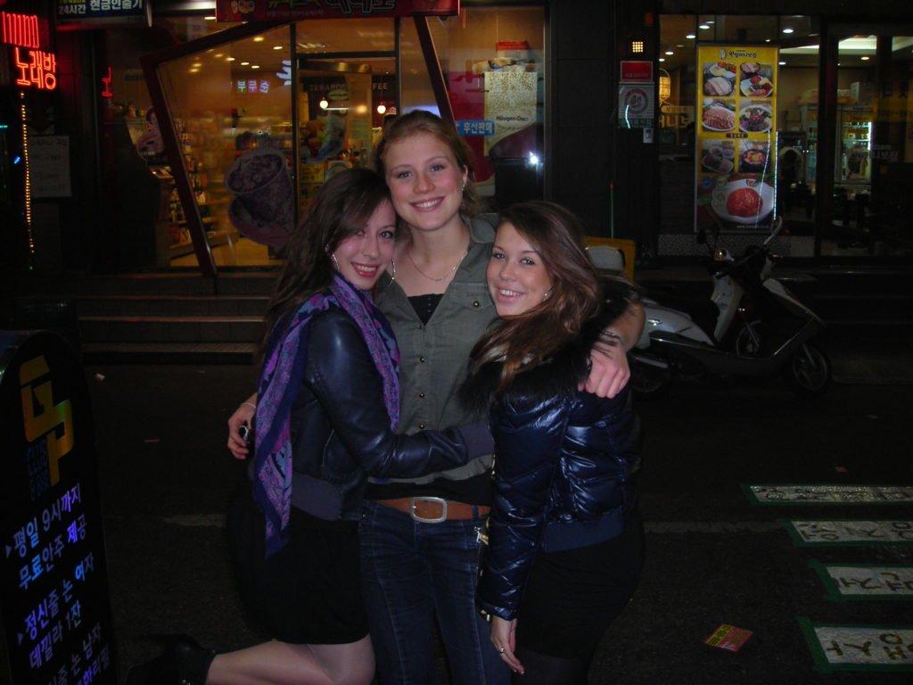 Two young people smiling and exploring a new city during a summer language camp abroad excursion.